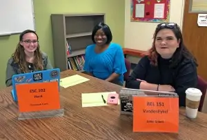 Dr. Bryant sits with two PAL tutors, Savannah Farris and Jamie Gilbert.