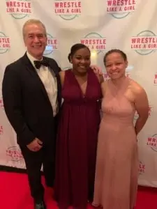 Talum Smith '20 (center) stands with President David Johns and Head Women's Wrestling Coach Breonnah Neal.