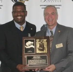 Adams stands with President David Johns during Adams' 2019 induction into the Ferrum College Sports Hall of Fame.