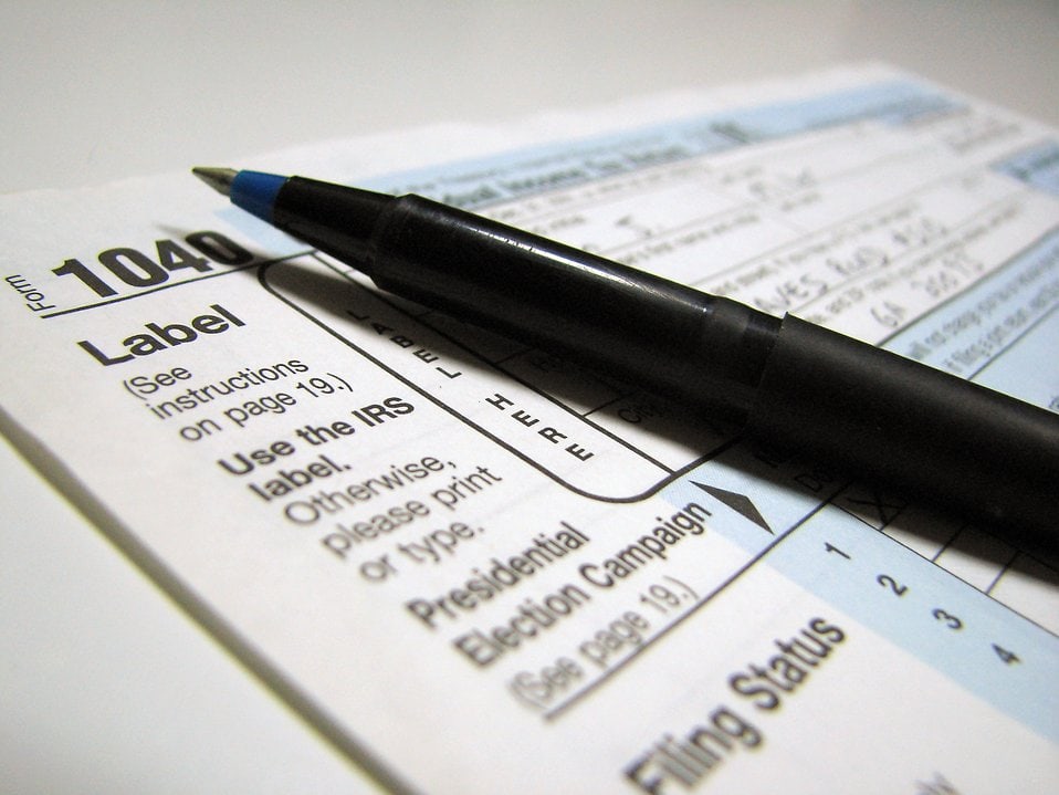 Close up of 1040 tax form with a pen