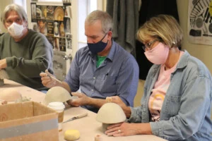 Volunteers making bowls for Empty Bowls event