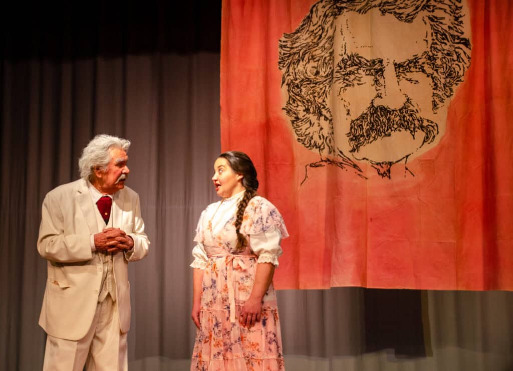 Rex Stephenson in costume as Mark Twain with Emily Blankenship-Tucker on stage