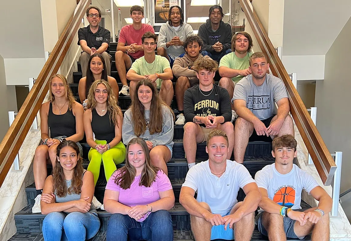 Ferrum College Boone Honor students sitting on the stairs of the Stanley Library.