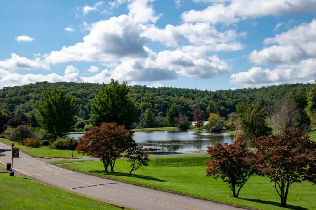 Image of Adams Lake at Ferrum College on a pretty fall day with blue sky and puffy white clouds