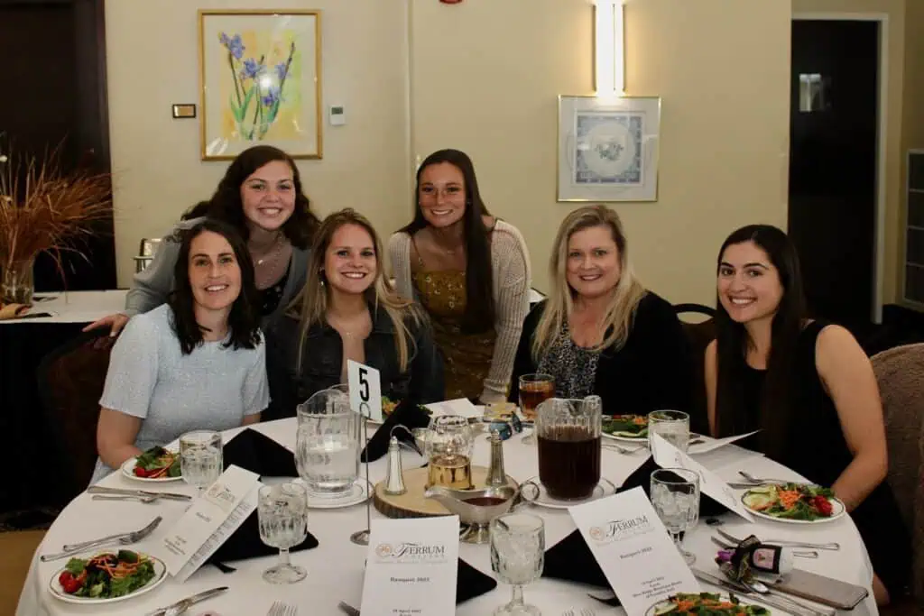 Boone Honors students sit around a dinner table with two advisors.