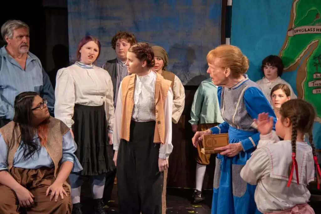 Cast of Treasure Island in performance in 19th-century costumes
