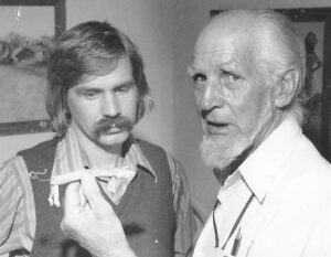 Rex Stephenson in shirt and vest with Richard Chase in white shirt holding a prop or toy