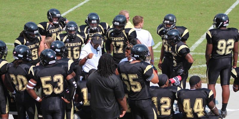 Coach Adams having an in-game discussion with Ferrum Football players.