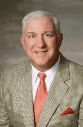 John Cougill in tan suit and light tie