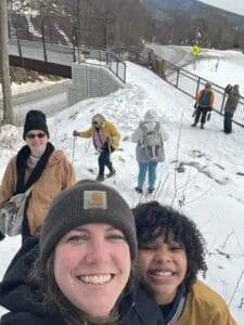 Selfie with seven people of different ages in winter clothing hiking on the snowy Appalachian Trail 