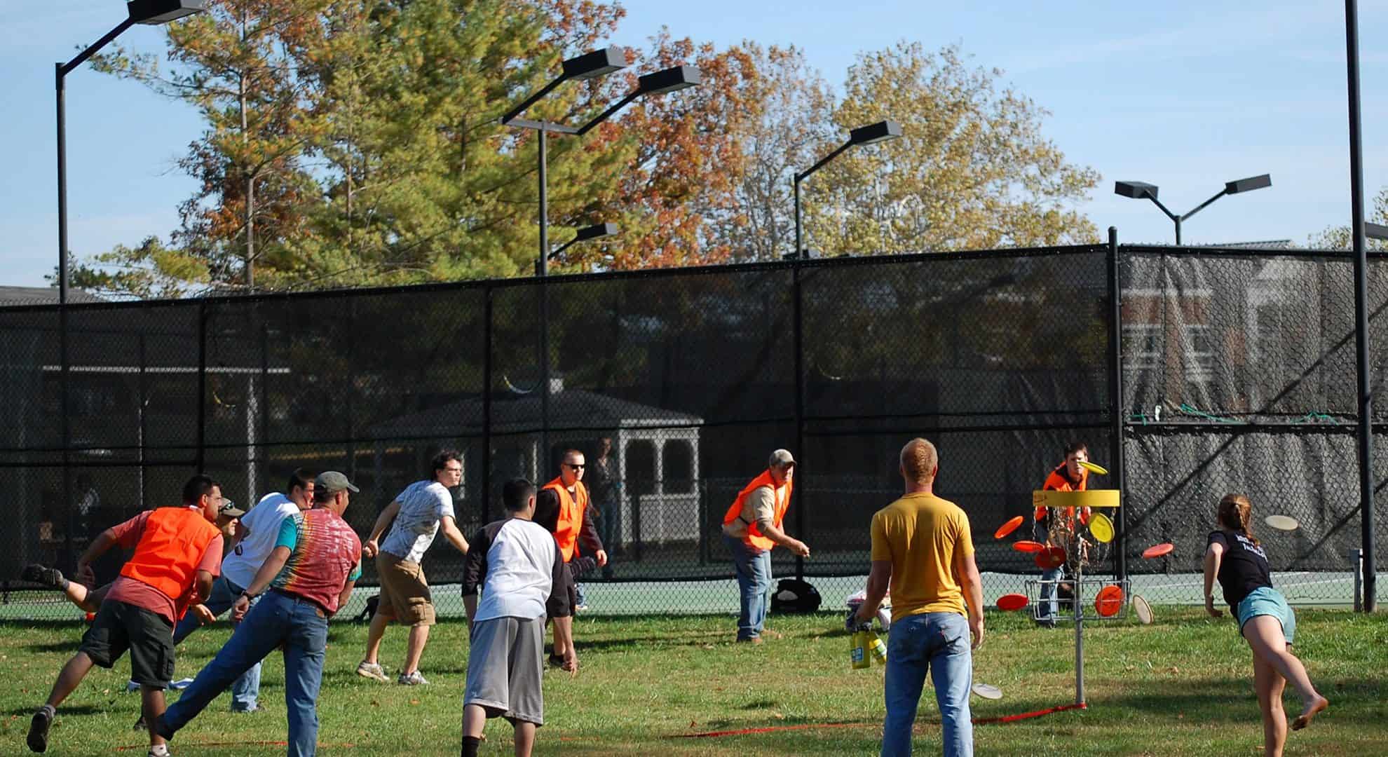Ferrum College students playing disc golf on campus.