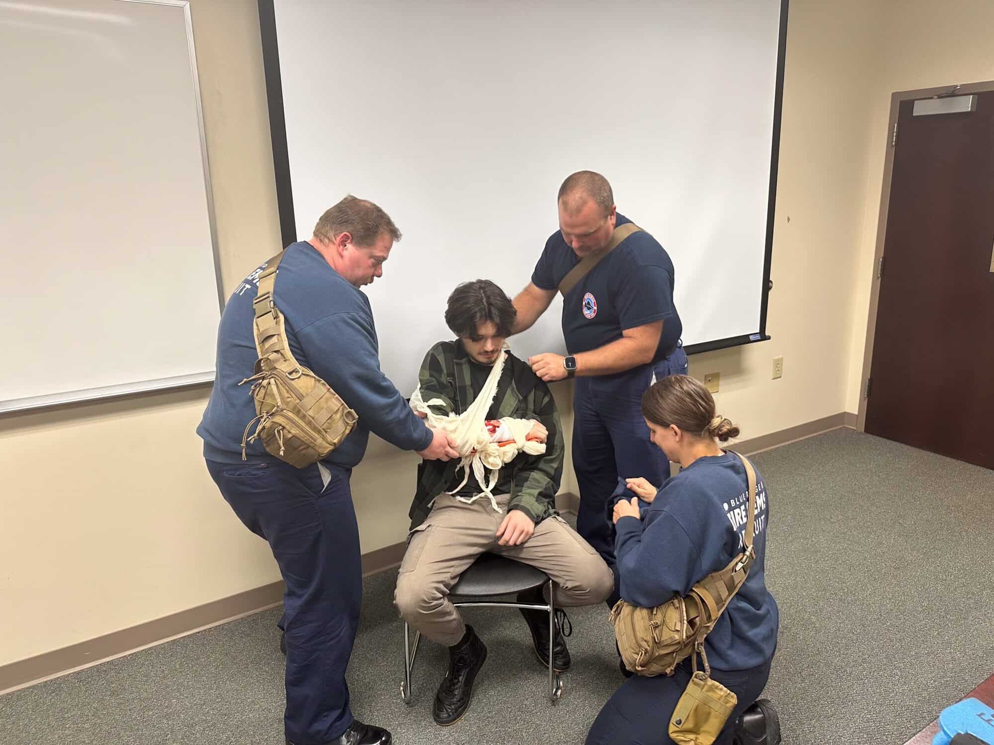 Trainees practice putting a sling on an injured vitim.