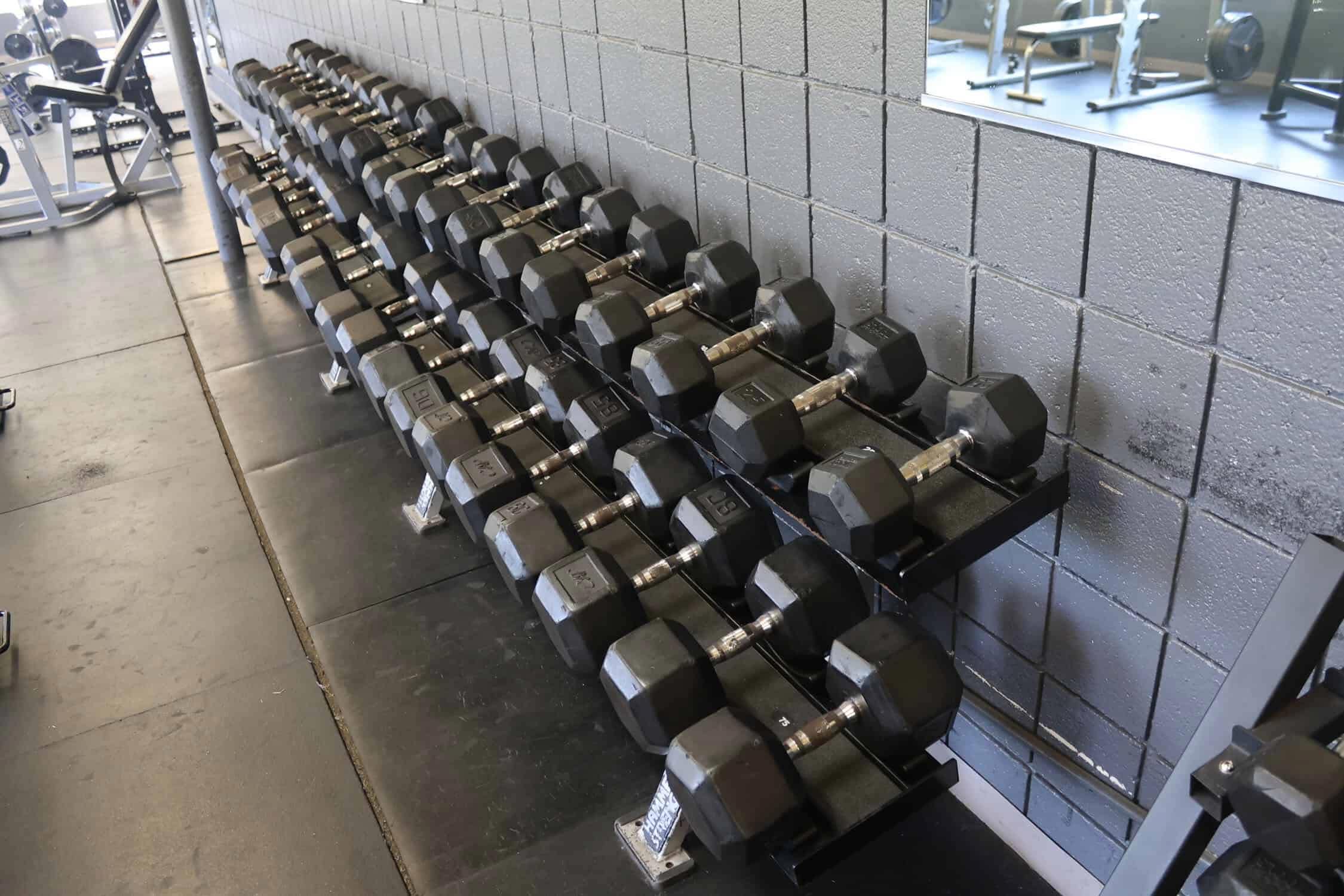 The dumbbell rack ordered from the lightest to heaviest. The heads of the dumbbells are coated in rubber with the handles being steel.
