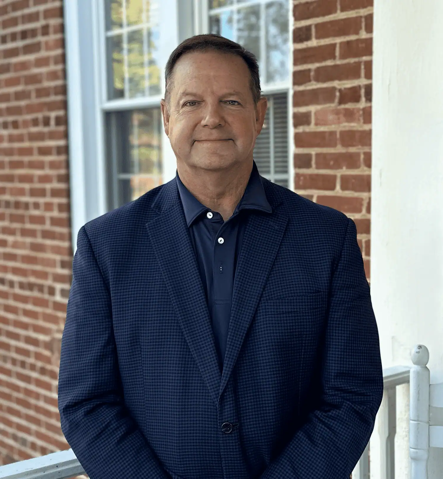 Headshot of Jim Patterson on the front porch of John Wesley Hall
