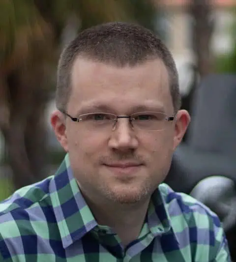 Headshot of Ferrum College professor Ryan Bates wearing plaid shirt.