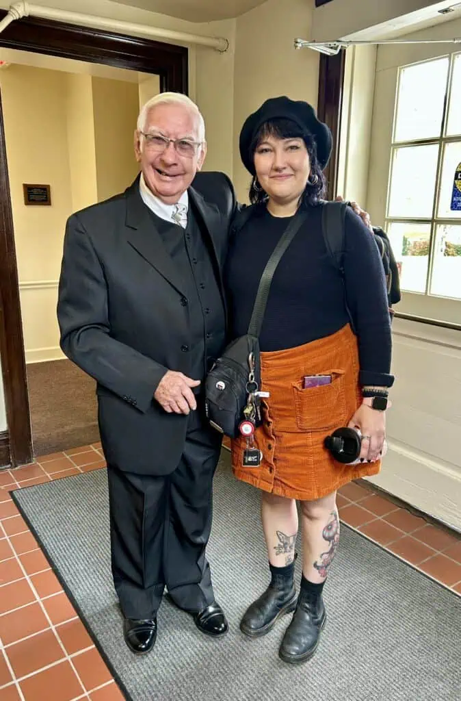 Dr. William Wray with senior Scout Lynch in doorway of Britt Hall at Homecoming