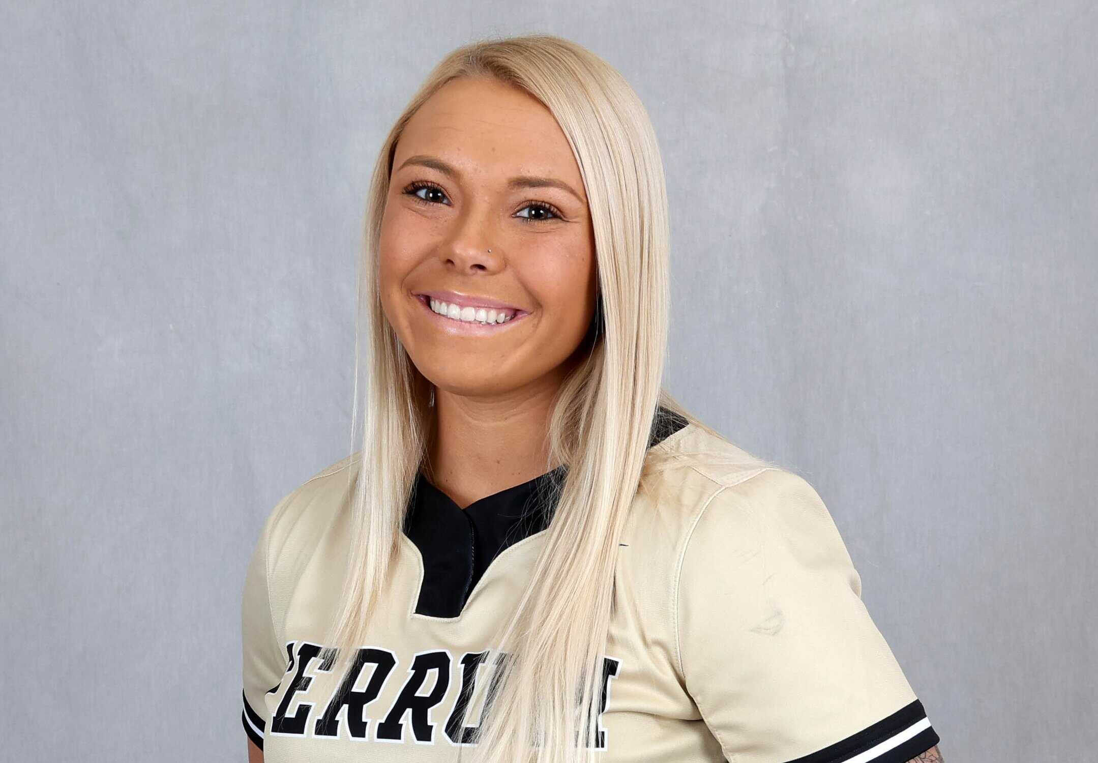 Headshot of Breanna Weaver with long blonde hair, in light gold with black trim Ferrum softball jersey