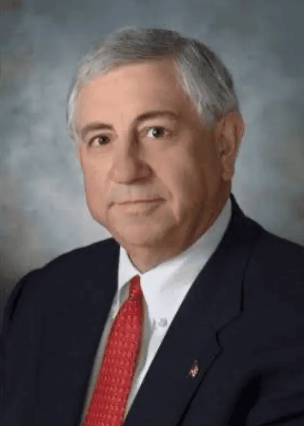 Headshot of George Yancy in dark suit and red tie