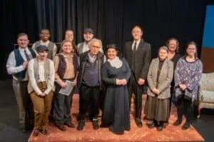 The cast and crew of the January 2025 production of "You Caught Me Dancing" are gathered around the late Ferrum College Professor Emeritus Rex Stephenson, who directed the play.