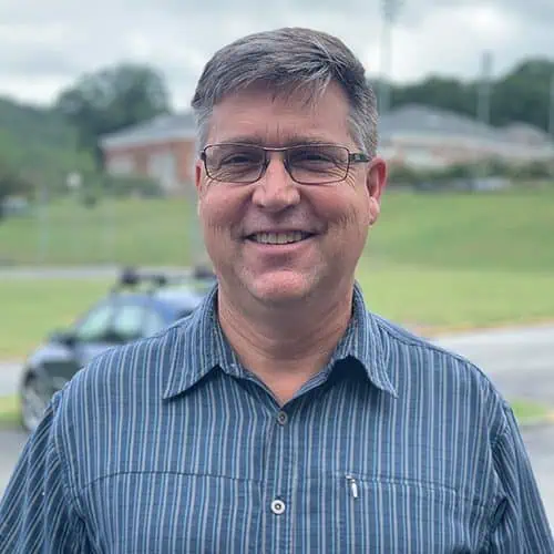 Headshot of Ferrum College professor Dan Caston standing outside of campus.
