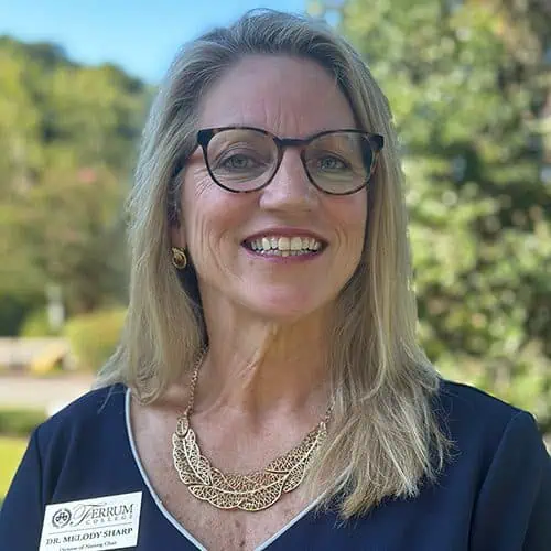 Headshot of Ferrum College staff Melody Sharpe standing outside on campus.