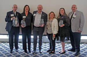 The Ferrum College 2025 alumni award recipients pose with their award vases