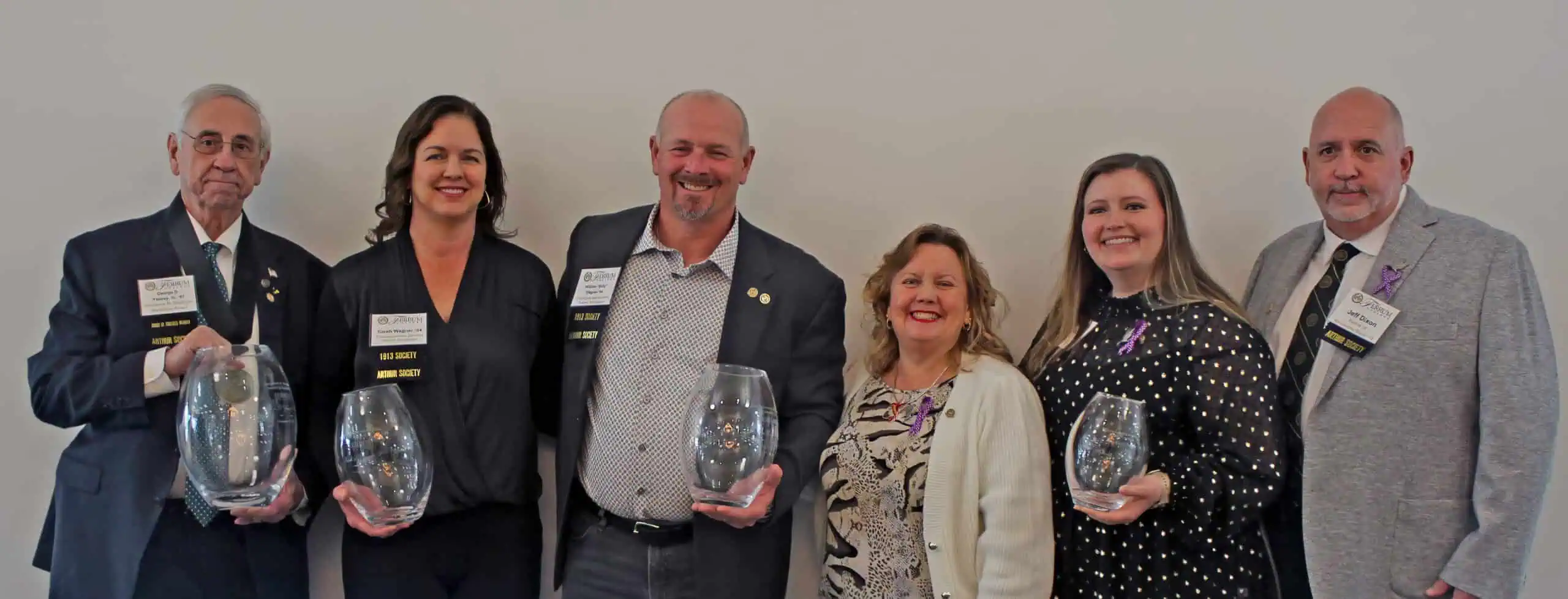 The Ferrum College 2025 alumni award recipients pose with their award vases