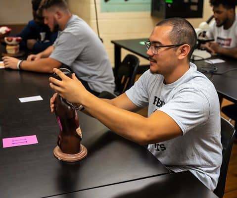 Ferrum College student working with a model in the anatomy lab