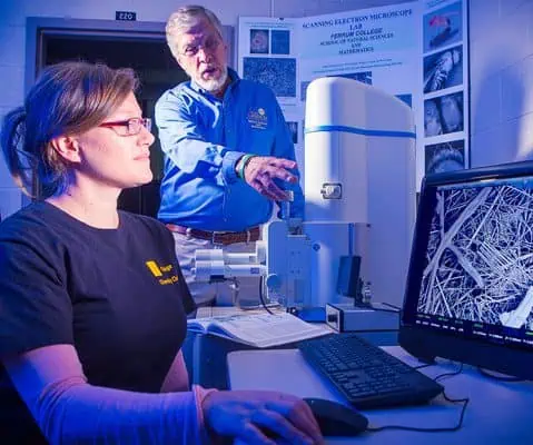 bob pohlad teaching female student in laboratory