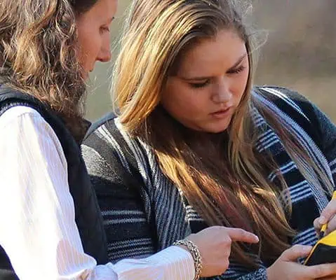 close up photo of female professor helping a female student