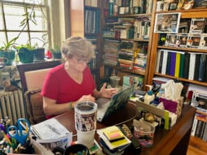 Dr. Lana Whited writes at her desk in Britt Hall at Ferrum College