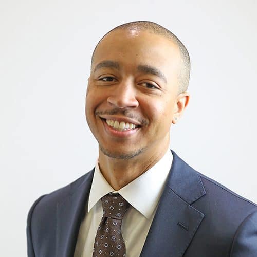 Photograph of Ferrum College Adjunct Instructor of Teacher Education wearing a dark suit, white shirt, tie and pocket square
