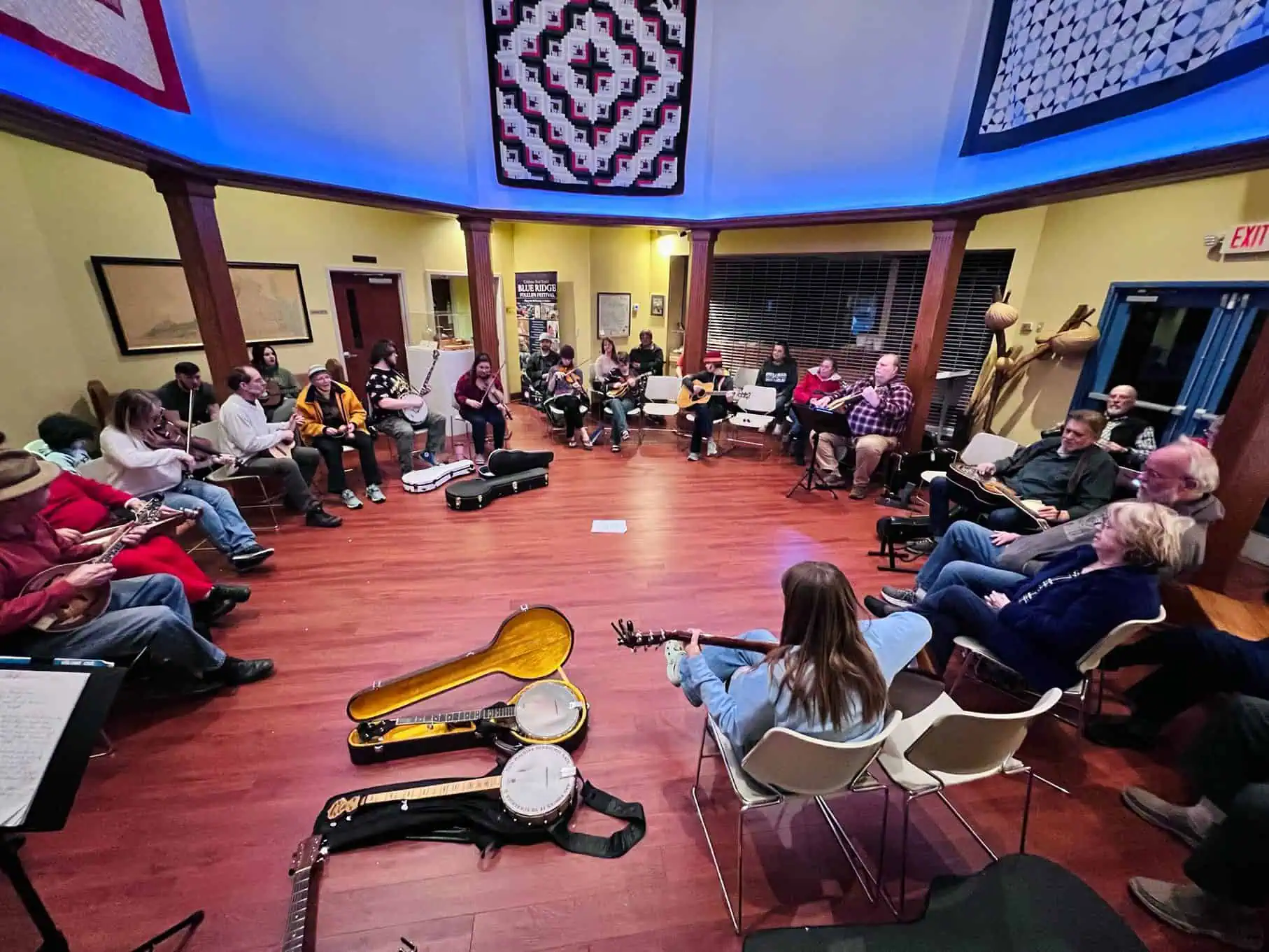 People gathered around playing instruments in the Blue Ridge Institute and Museum.