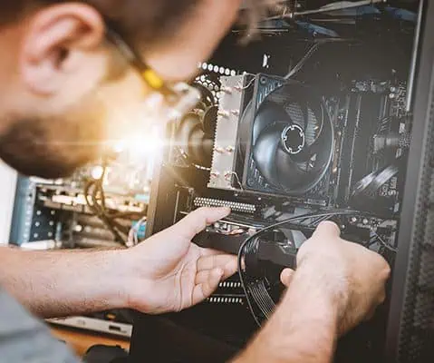 male inspecting the inside of a computer monitor