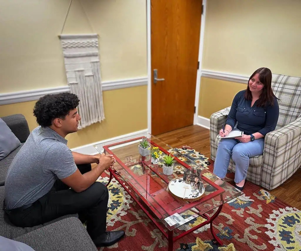 A student and Ferrum College's Counselor have a chat in her office.