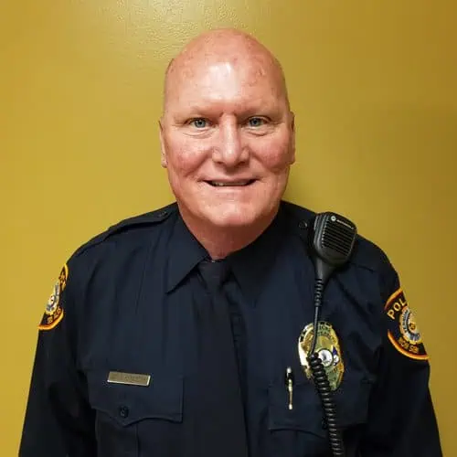 officer howard painter in uniform in front of yellow background for staff photo