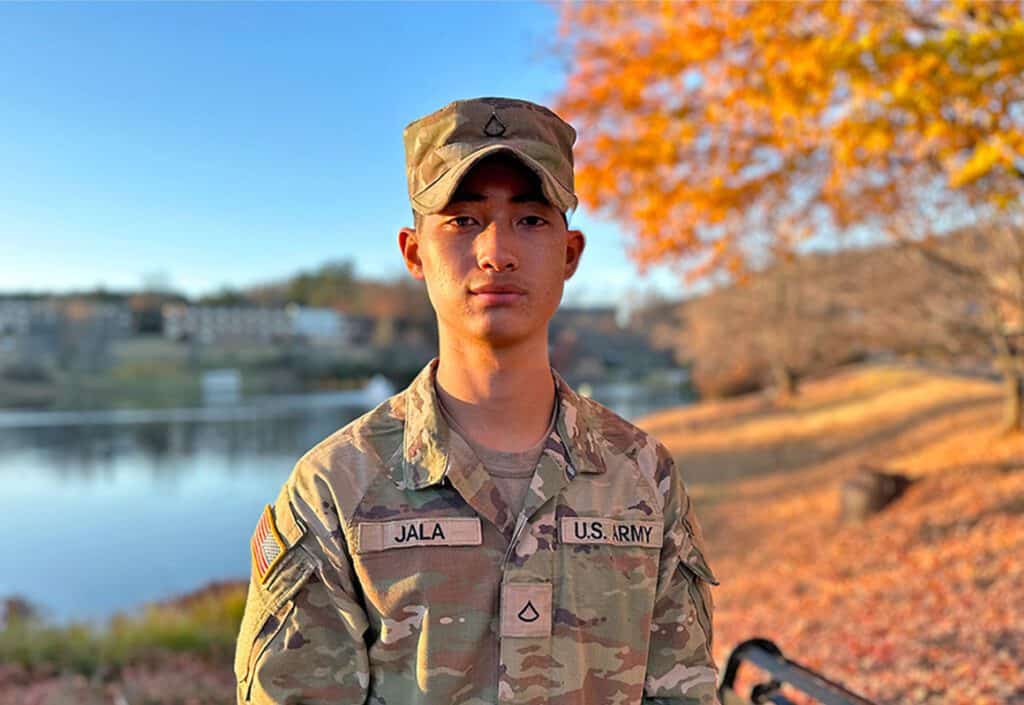 Ferrum College student Tripoom Jala standing at Adams Lake on campus