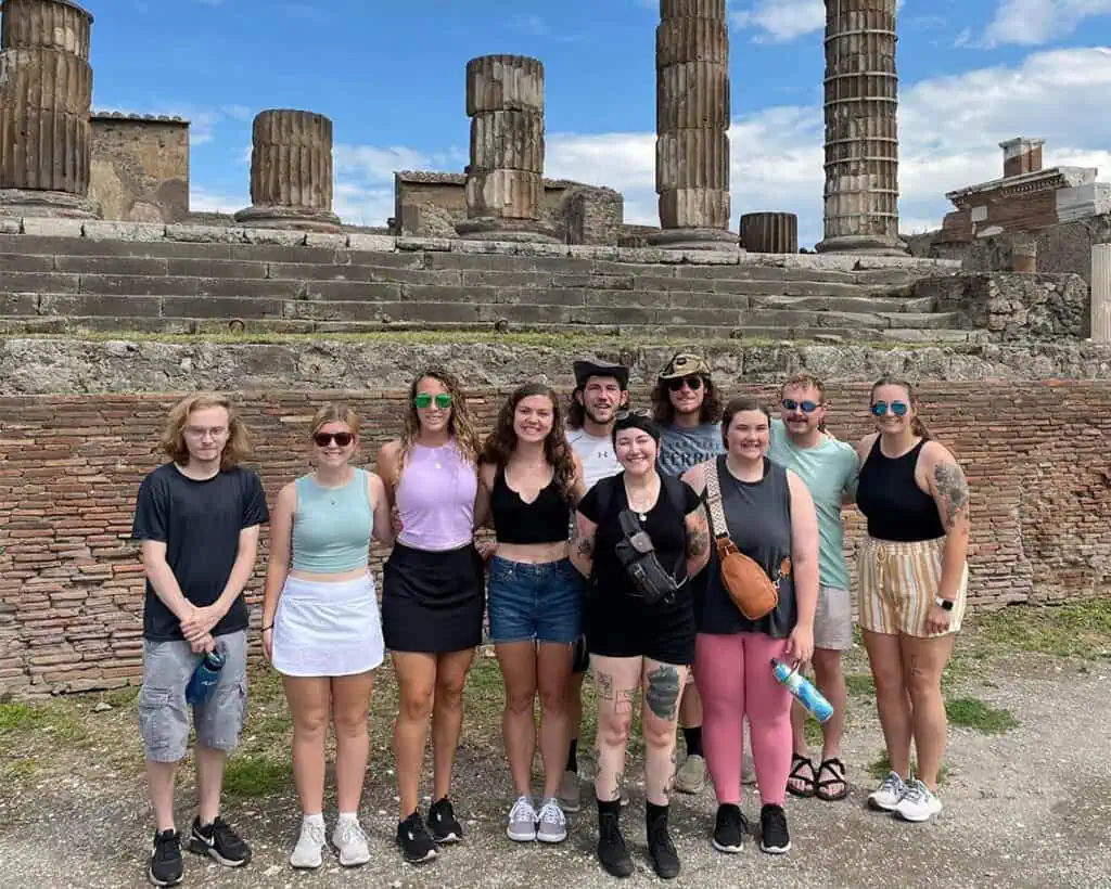 Ferrum College students standing outside behind a structure in Italy.