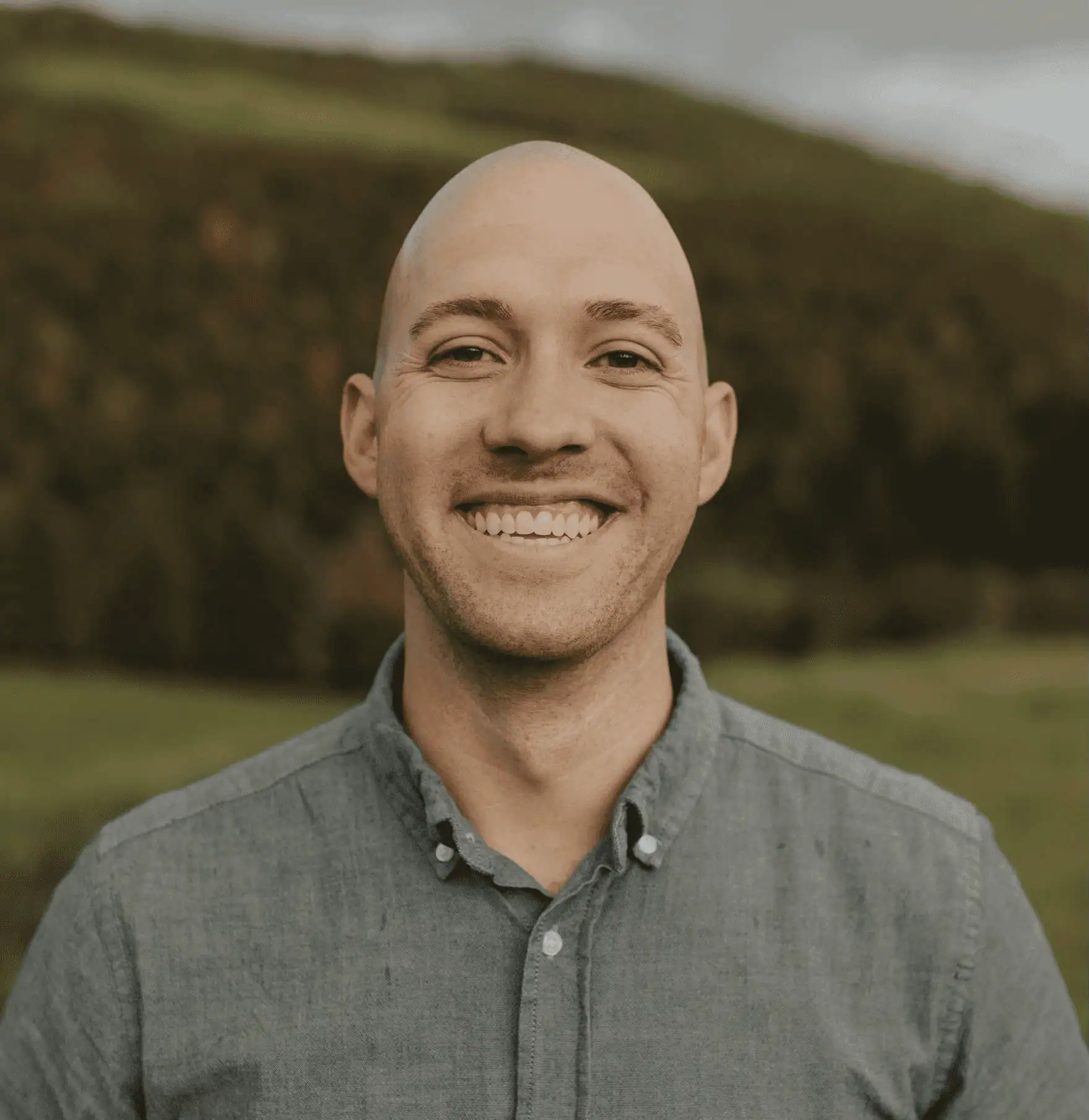 Headshot of McKay Visser smiling and wearing a grey button down.