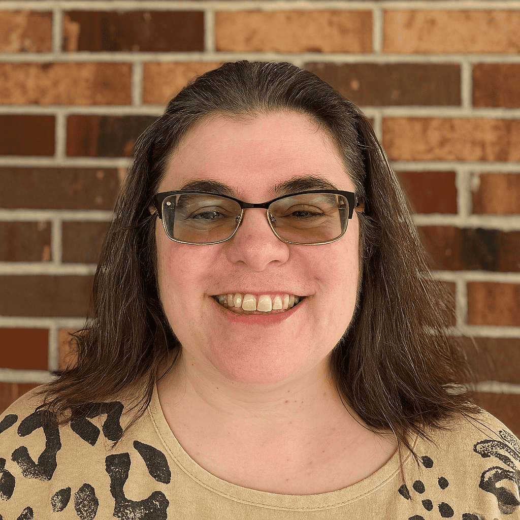 Photo of Sharon Stein standing in front of a brick wall